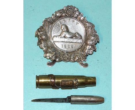 An Egypt 1882 medal, (inscription unreadable), set into a silver menu holder, Birmingham 1897 and a trench art bullet penknif