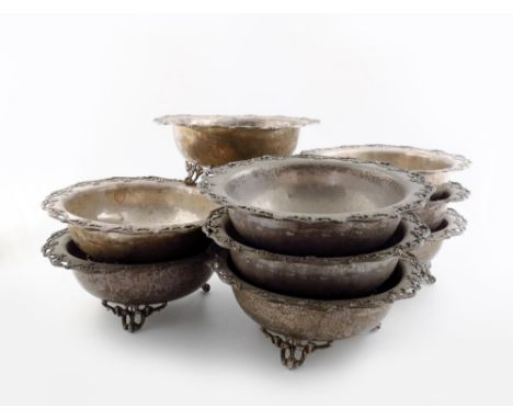 A set of nine electroplated bowls, by G.G and S, circular form, with a pierced foliate border, on three pierced scroll bracke