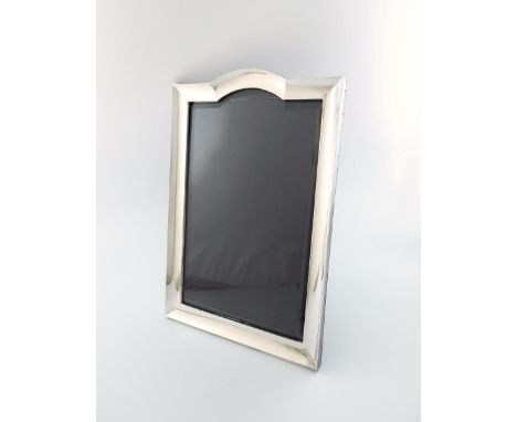 A large silver photograph frame, by H. Matthews, Birmingham 1910,  upright arched rectangular form, replacement silk back and