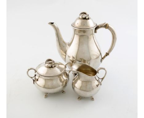 A three-piece Danish silver coffee set, by Villads-Neilsen, Copenhagen 1932, baluster form, spot-hammered decoration, the dom