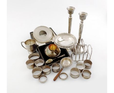 A mixed lot of silver items, various dates and makers, comprising: a five-bar toast rack, Sheffield 1921, a pair of candlesti