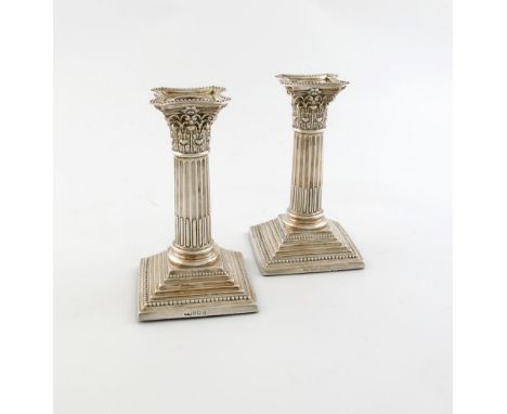 A pair of late-Victorian silver candlesticks,  The Harrison Brothers and Howson, Sheffield 1890, Corinthian column form, bead