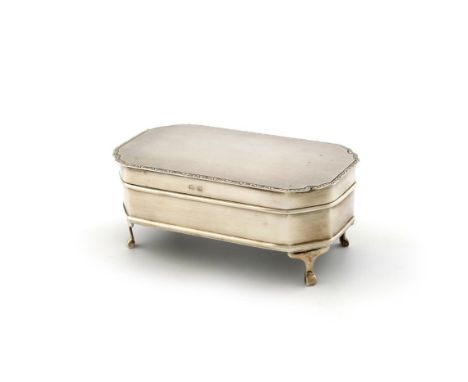 A silver dressing table box, by The Adie Brothers, Birmingham 1931, shaped rectangular form, engine-turned cover, engraved bo