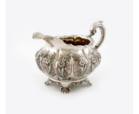 A William IV silver cream jug, maker's mark of ML, unidentified, London 1834, circular lobed form, embossed foliate decoratio