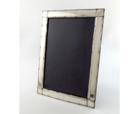 An Edwardian silver photograph frame, by The Cooper Brothers, Birmingham 1908, rectangular form, reeded and foliate borders, 