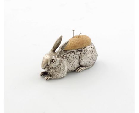 A novelty Edwardian silver pin cushion, by Adie and Lovekin, Birmingham 1908, modelled as a recumbent rabbit, length 6.5cm.