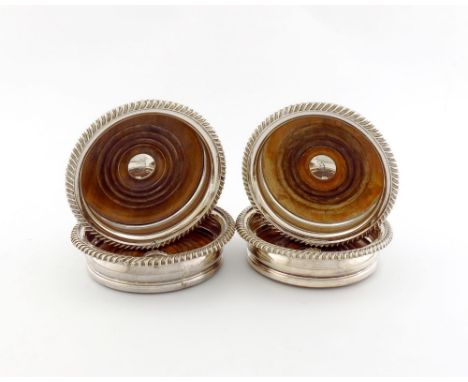 A set of four early 19th century old Sheffield plated wine coasters, unmarked circa 1810-20, circular form, gadroon borders, 