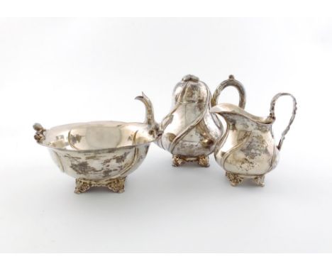 A matched 19th century three-piece Dutch silver strawberry tea set, the teapot and cream jug, of baluster form, swirl decorat