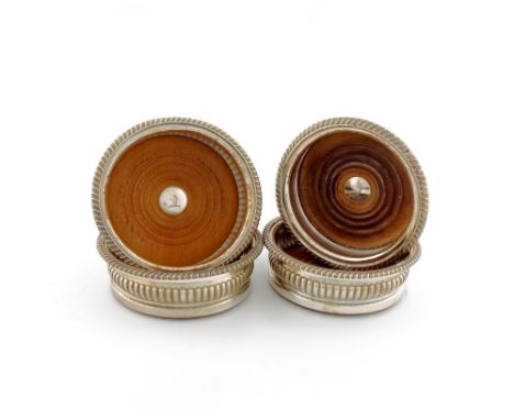 A set of three early 19th century old Sheffield plated wine coasters, unmarked circa 1810-20, fluted circular form, gadroon b