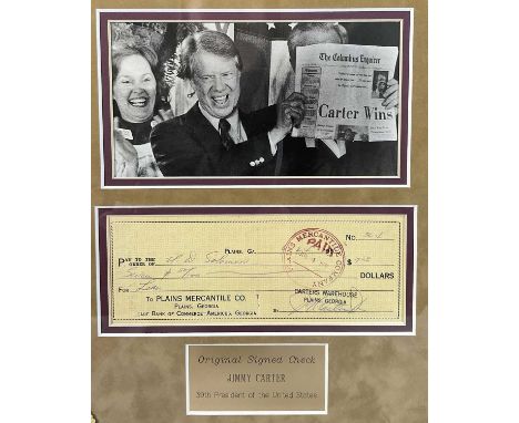 AUTOGRAPHS - A JIMMY CARTER signed cheque cased in a display frame with a photographic still and plaque reading Original Sign