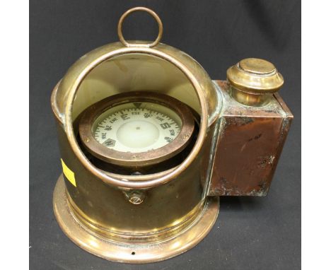 An early 20th century ships brass binnacle gimbal wet compass, in brass binnacle housing, the side fitted with a small spirit