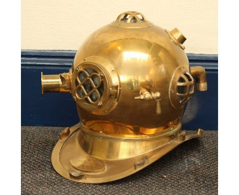 A modern decorative reproduction brass deep-sea divers helmet, with wall-mounting bracket.  