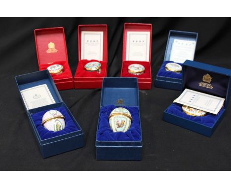 A collection of seven Halcyon Days enamel pill boxes, all in original boxes, for Christmas and Easter gifts.