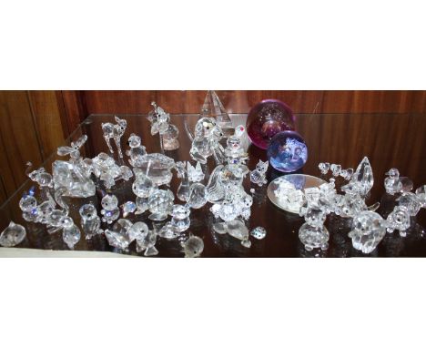 A collection of Swarovski and other cut crystal animals and ornaments, together with two Caithness paperweights.