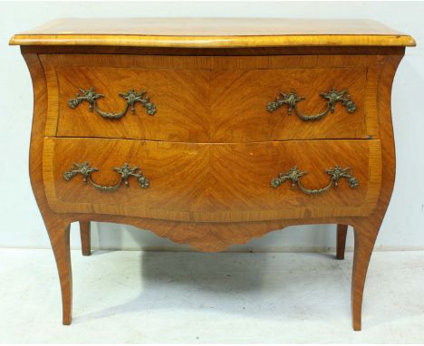 An early 20th century French kingwood parquetry veneered bombe commode, with serpentine front and sides, comprising two drawe
