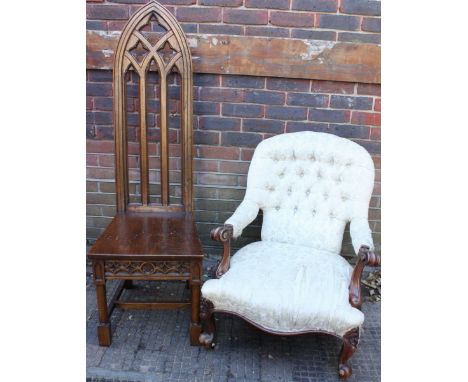 A Victorian walnut armchair, with a deep button back and floral, cream upholstery, scrolling arms, serpentine front and raise