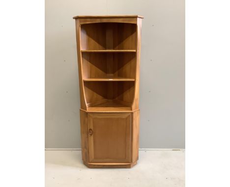 An Ercol elm standing corner cabinet, width 72cm, depth 41cm, height 179cm
