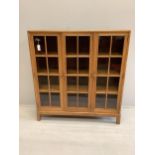 An early 20th century Heal & Son, London glazed walnut three door bookcase, width 122cm, depth 29cm,