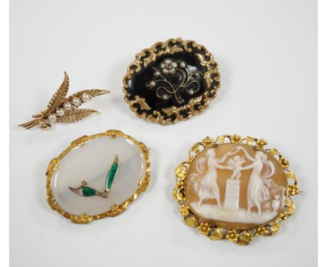 A Victorian yellow metal, black enamel and seed pearl set mourning brooch, 43mm, two other yellow metal mounted brooches, inc