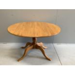 A modern Ercol elm dining table, width 110cm, depth 98cm, height 72cm (lacks spare leaf)