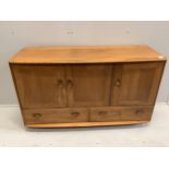 An Ercol Windsor elm sideboard, width 130cm, depth 47cm, height 76cm