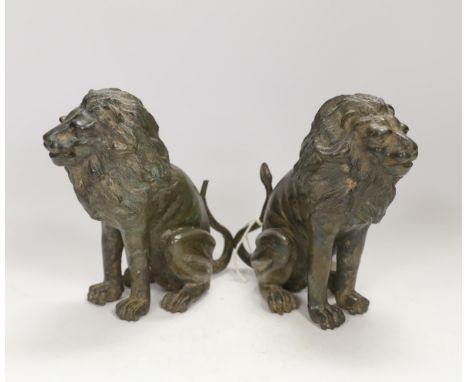 A pair of bronze models of seated lions, 17cm