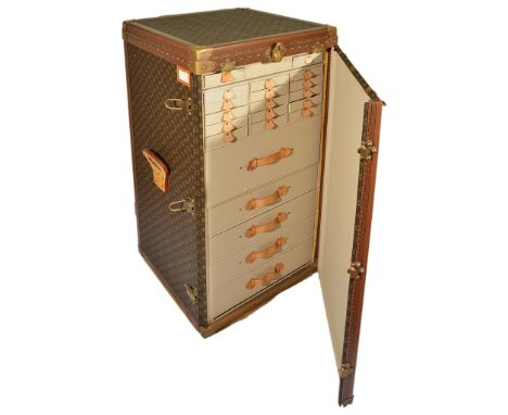 A Louis Vuitton Trunk Model 387:A large trunk with lifting top and swing-out hinged door opening to reveal 22 drawers and two