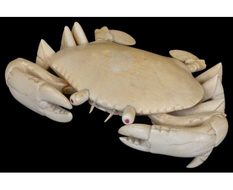 A Japanese Ivory Okimono (Meiji Period) Realistically Carved as a Crab:With inlaid red semi-precious stones in the protruding