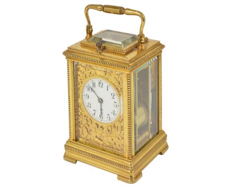 A French Brass Repeater Carriage Clock:Gilt brass beaded case with filigree floral cover surrounding the dial, original platf