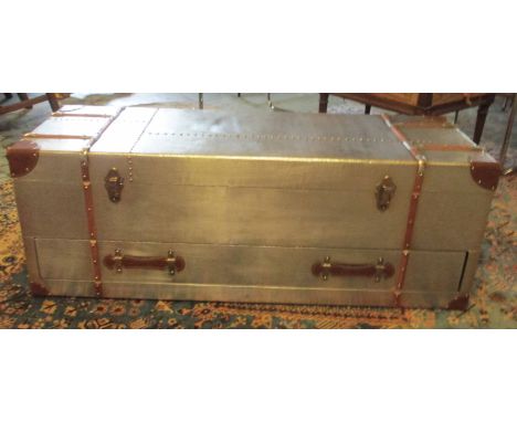 AVIATOR STYLE TRUNK, tan leather bound with a rectangular rising top enclosing space for storage, a handle to each side and a