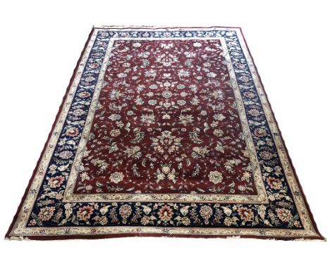 FINE PART SILK TABRIZ DESIGN CARPET, 279cm x 185cm, all over palmettes and vine ruby field, within corresponding borders.