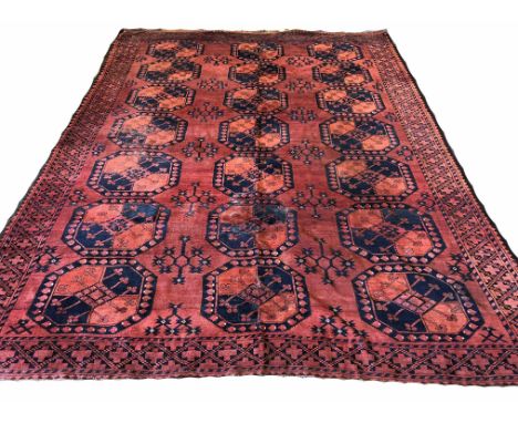 ANTIQUE AFGHAN ERSARI CARPET, 337cm x 247cm, rows of tribal guls on a ruby red field, within corresponding borders.