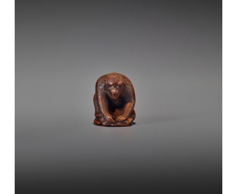 AN AMUSING WOOD NETSUKE OF A MONKEY HOLDING DOWN A FROGJapan, Gifu, 19th century, Edo period (1615-1868)A comical wood netsuk