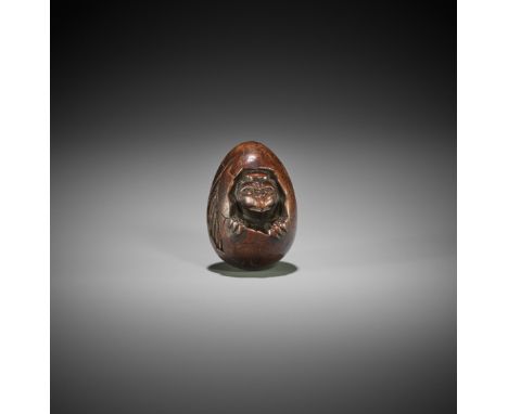 A WOOD NETSUKE OF A HATCHING TENGU (TENGU NO TOMAGO)Japan, late 18th to early 19th century, Edo period (1615-1868)The ideally