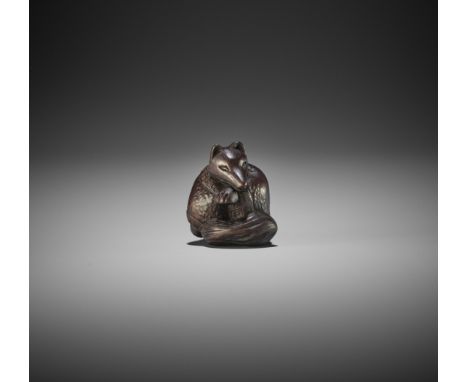 HIDARI ISSAN: A DARK WOOD NETSUKE OF A KITSUNEBy Hidari Issan, signed IssanJapan, Mutsu (Iwashiro) Province, 19th century, Ed