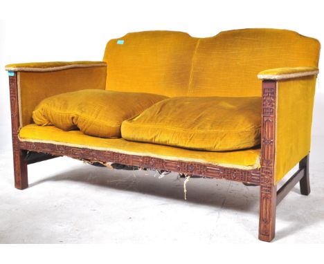 An Art Deco early 20th century circa 1920s upholstered &amp; oak wood two seater. The sofa being in an upholstered ochre colo