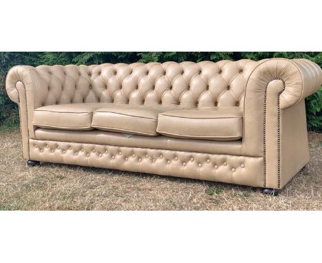 A contemporary Thomas Lloyd Chesterfield three person tan sofa having button back detailing with studded decoration. Sofa com