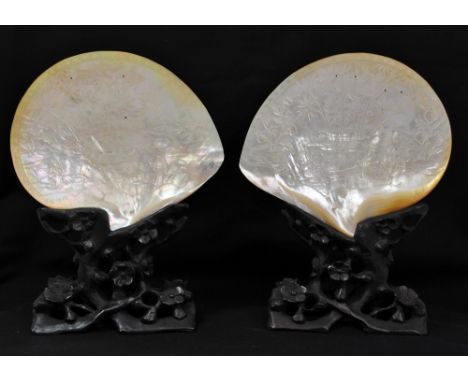 A pair of late 19th/early 20th century Chinese carved and inlaid mother of pearl shells, each depicting figures and birds amo