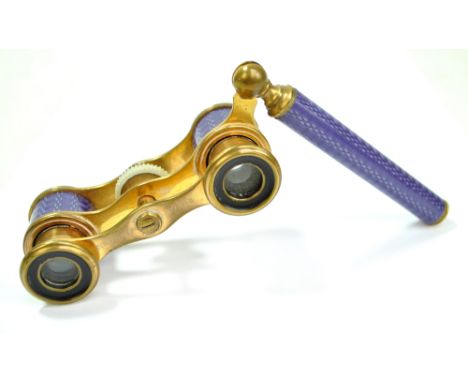 ZINGRIFF OF PARIS; a pair of early 20th century French gilt metal and purple simulated guilloche enamel opera glasses with fo