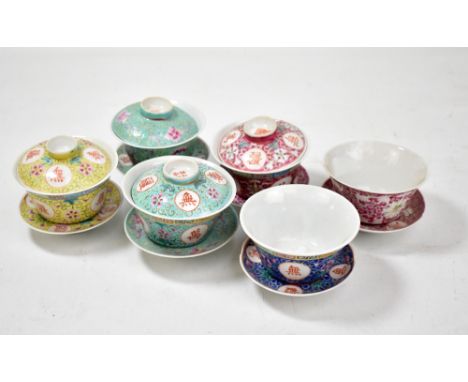 A collection of 20th century enamel decorated Chinese porcelain rice bowls and stands (two lacking covers).