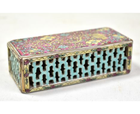 A Chinese Canton enamel decorated rectangular wrist rest with iron red seal mark to base, width 11.5cm.Additional Information