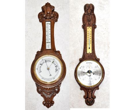 An oak barometer with carved detail, length approx 88cm, and a smaller example (2).&nbsp;