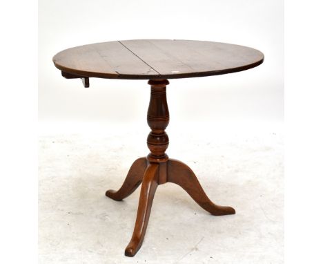 A 19th century and later oak tilt top tripod table with ring turned baluster column, diameter 89cm.