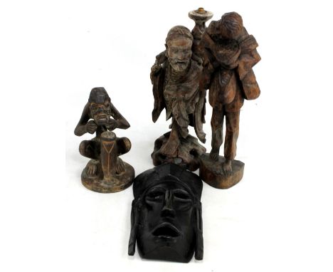 A Chinese rootwood carving of a robed skeletal figure, his travelling bag with light fitting to top, height 36cm, two carved 