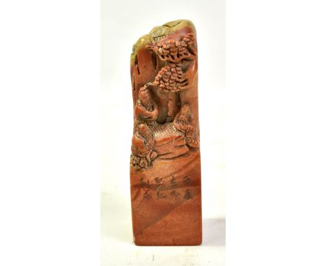 A Chinese carved soapstone square section seal carved with three men at the table playing Weiqi beneath a tree in mountain an