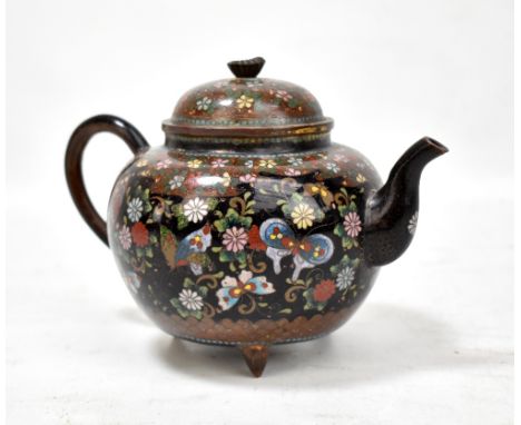 A Japanese Meiji period cloisonne enamel teapot overall decorated with butterflies amongst floral sprays, with flower head fi