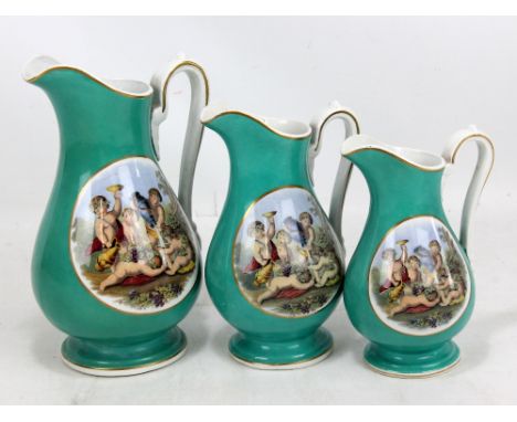A set of three graduated ceramic jugs, each featuring twin transfer decorated panels of cavorting cherubs against turquoise g