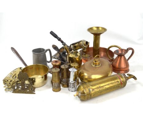 A mixed group of metalware including brass and copper chamber stick, copper half pint measure, brass blowtorch, four miniatur