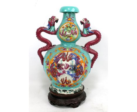 An early 20th century Chinese porcelain fahua-style double gourd vase, with twin dragon handles and central panels decorated 