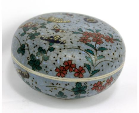 A late 19th century Chinese porcelain circular box and cover decorated in simulated cloisonné with floral sprays throughout, 